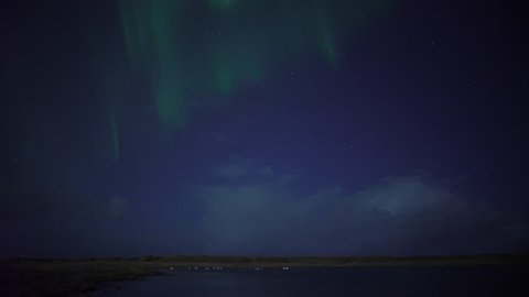 Aurora borealis and stars over swans in lake, Grotta Iceland.mov
