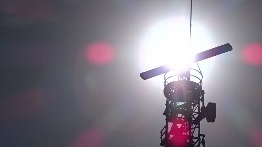 A large radar rotating in the glow of the sun. A silhouette of the radar can be seen.