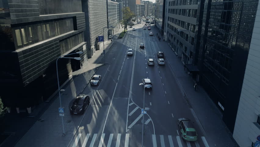 Top Down Aerial Drone Tracking Shot of of Cars Moving on Freeway Through City Traffic at Daytime.
