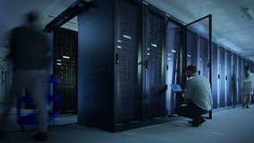 Time Lapse Footage of IT Employees Working in a Data Center Server Room. Technicians and Engineers Running Diagnostics and Maintenance, Inspecting Server Racks. - Powered by Shutterstock - Get 15% off with code: PIKWIZARD15
