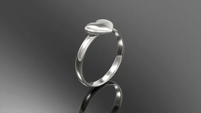 4K Loop Animation of White Gold Ring with Heart Shape. Love and Romantic Symbol on black background