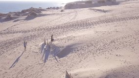 Aerial view of videographer and model working together at Tarifa Beach , Cadiz , Spain 