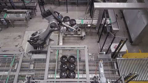 Large mechanical automated robot lifting and moving items in an industrial brewery