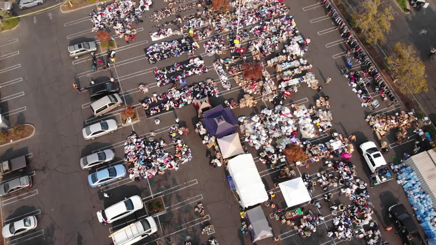 Aerial top-down panning of parking lot distribution center for Camp Fire evacuees in California