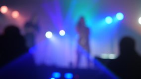 light two singers spotlight concert retro music concert pop band blurred background. slow motion video. two girls singer singing into a microphone lifestyle