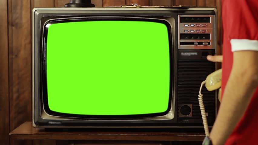 Young Man using an Old Phone Turning On and Off Retro TV with Green Screen. You can replace green screen with the footage or picture you want. You can do it with “Keying” effect (check out tutorials). | Shutterstock HD Video #1022110198