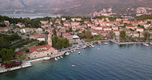Panning aerial shot with close view of small Croatian village on sea front.