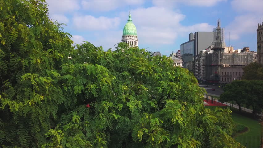 Flight over the National Congress of Argentina and Plaza de Mayo with the tree on the foreground. Buenos Aires