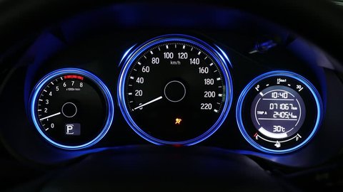 close up dashboard of mileage car with over 70,000 kilometers (engine start)