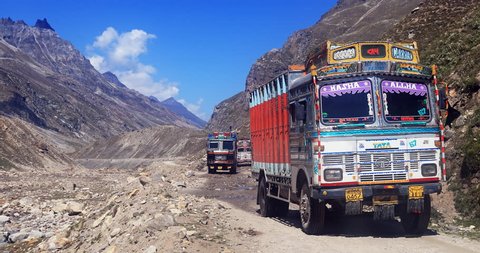LADAKH, INDIA 18 SEP 2017: Decorated indian trucks drive in mountain valley of Himalayas