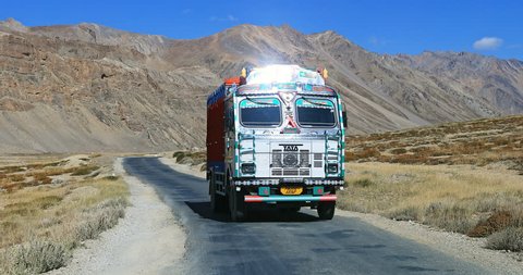 LADAKH, INDIA 18 SEP 2017: Traffic in Himalaya mountains, traditional indian decorated truck drives in remote region of Ladakh, north India