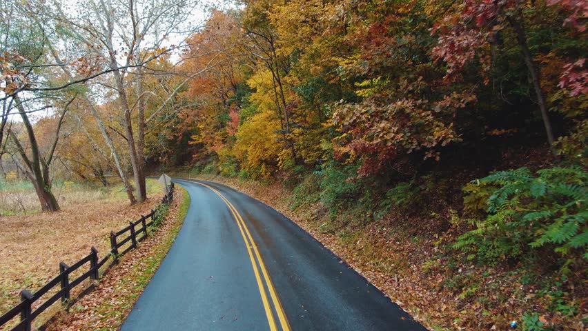 Aerial dolly, Autumn foliage on beautiful empty country road, Lancaster County, Pennsylvania.