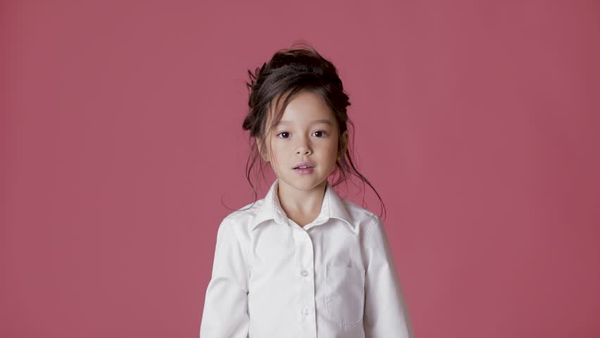 cute little girl in white shirt shows different emotions on pink background. lot of gestures and facial expressions of child Royalty-Free Stock Footage #1022146381