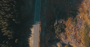 Direct Overhead Aerial Drone Shot Following a Lonely Road through the Mountain Side.
