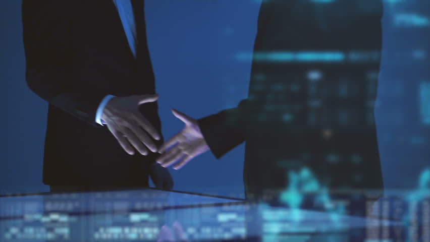 The two businessmen handshake on the hologram background. slow motion Royalty-Free Stock Footage #1022151244