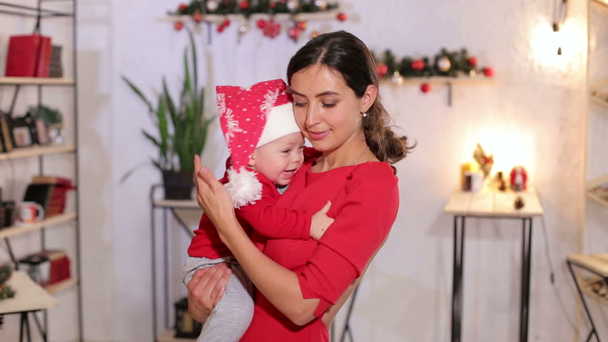 Portrait of family at home for Christmas. Portrait of happy little baby in santa