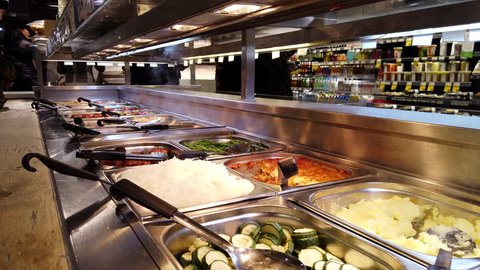 FULHAM, LONDON - JANUARY 8, 2018: Hot food buffet in the self service section of Whole Foods Market in Fulham, West London, UK.