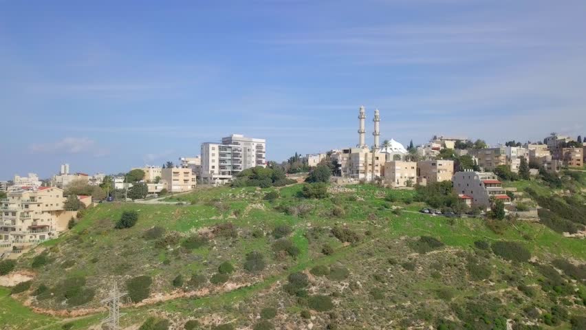 Aerial footage of the city of Haifa, Israel above and over the slopes of Mount Carmel.