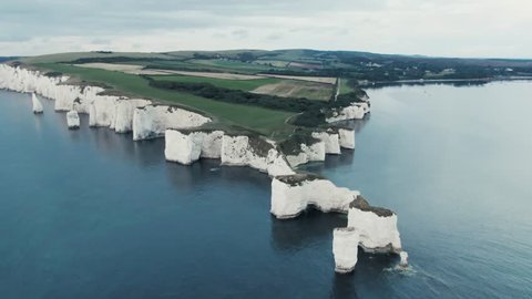 4K - Aerial Footage of Old Harry Rocks - England - Sunrise - Drone Revealing the land.