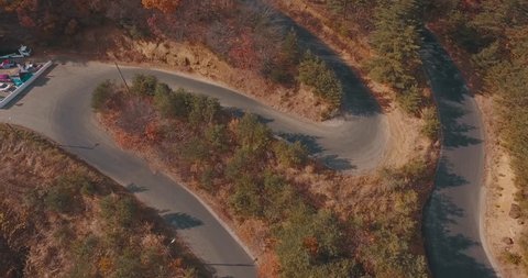 Aerial Drone Shot over a Mountain Race Track Exposing Some Intense Race Curves and Turns.
