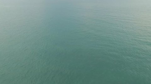 [Aerial] Drone pans up to reveal tropical islands