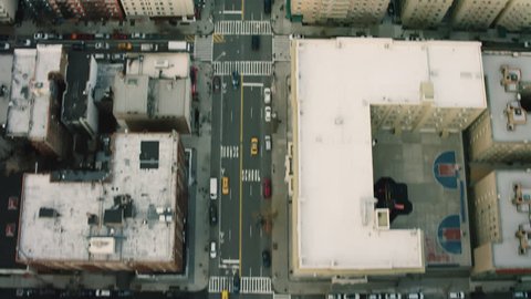 Top down aerial view of busy streets and buildings in Upper Manhattan, New York, on a dim day in winter. Wide shot. 4k shot with a RED camera.