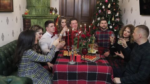 group of atractive young people celebrate new year in tartan style