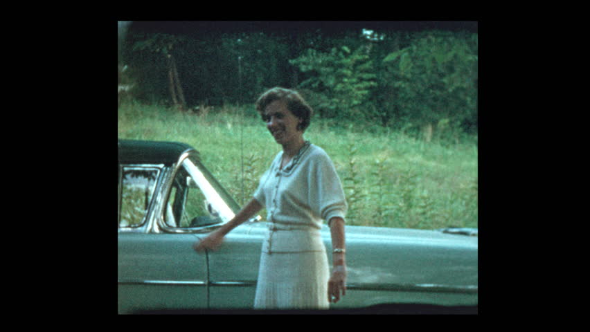 Proud Woman shows off new car 1953