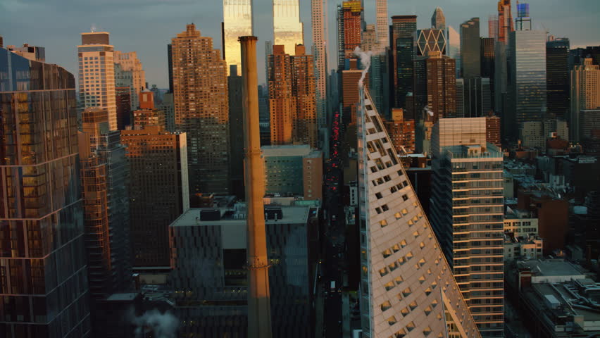 Aerial view of tall buildings and skyscrapers of downtown Manhattan, New York, during sunset in winter. Shot on 4k RED camera on helicopter