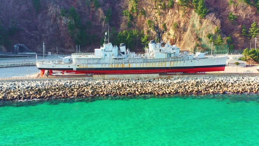 Aerial view, Seaside attraction are a warship and a red and green North Korean submarine. The 35m-long submarine was spying on military facilities near Gangneung in 1996 when it ran