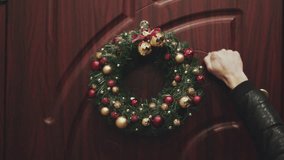 Wreath Christmas on the door. Hand of a man who knocks at the door - Powered by Shutterstock - Get 15% off with code: PIKWIZARD15