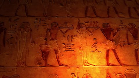 Ancient Egyptian artwork inside tomb of the pyramids lit by candle ALT