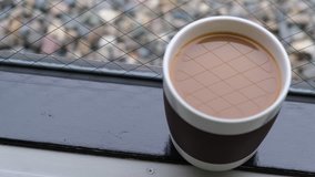 Milk coffee in a mug by the window. Panning to the right footage.