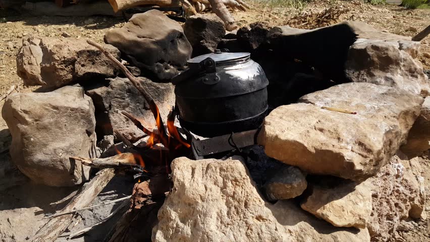 Tea kettle boiling on a wood fire in the mountain