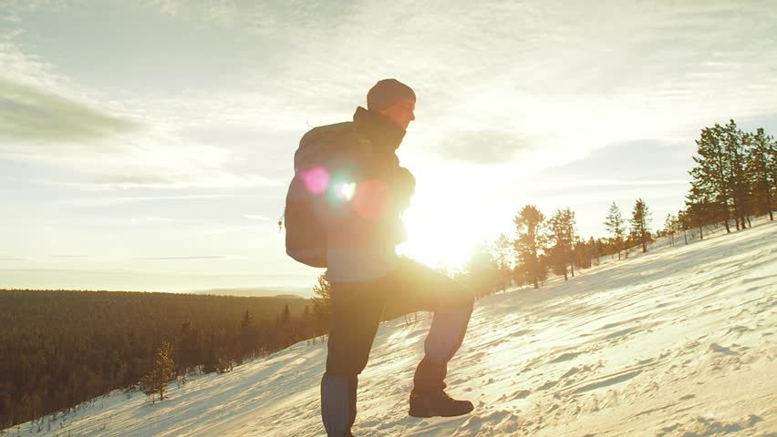 Hiker Hiking Snow Mountains Winter Hike. Extreme December Weather Cold Ice Landscape. People Trekking Mountaineering Concept. Mountain CLimbing Activity Winter Landscape. Backpacker Walking Snow