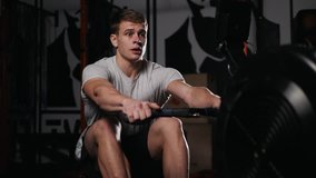 Young athlete doing rowing exercises in dark concept gym. - Powered by Shutterstock - Get 15% off with code: PIKWIZARD15