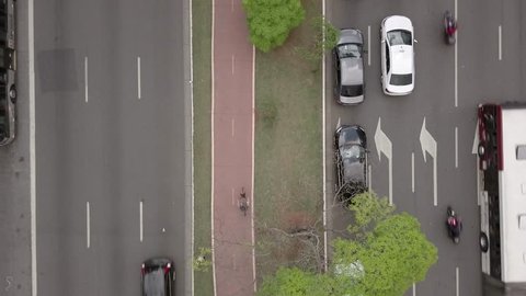 4K UHD Drone Shot of a Cyclist riding on a bike path between roads