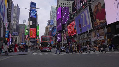 NEW YORK CITY, USA - NOVEMBER 21, 2018: Cars Traffic and People at Times Square at Day. Steadicam Shot, Moving Sideways over Road Intersection. Slow Motion