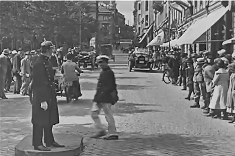 CIRCA 1923 - Busy city streets are shown in Berlin, including traffic around Brandenburg Gate.