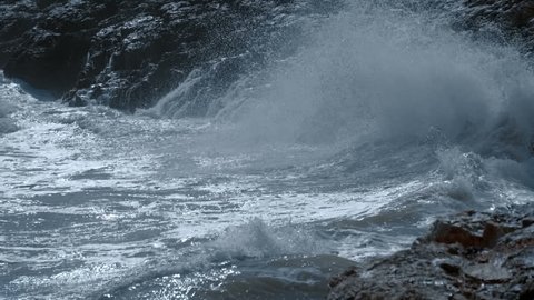 The waves of the storm sea hit the rocks and fly around with a lot of splashes. Slow mo, slo mo, slow motion, high speed camera, 240fps, 250fps