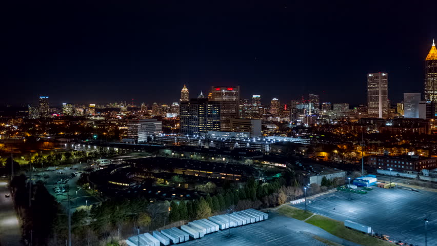 Atlanta Aerial v490 Hyperlapse flying toward downtown cityscape with dense freeway traffic at night 12/18