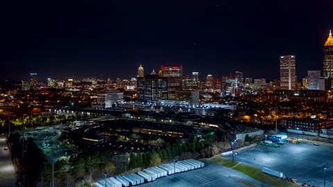 Atlanta Aerial v490 Hyperlapse flying toward downtown cityscape with dense freeway traffic at night 12/18