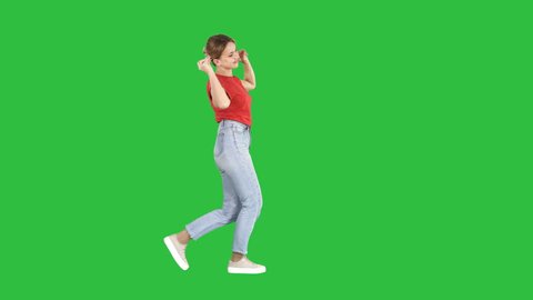 Happy smiling woman dancing and having fun on a Green Screen, Chroma Key.