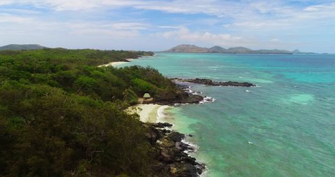 Beautiful aerial scenery of the beach and rocky shoreline of Turtle Island.  Turtle Island is one of many tropical islands that are located in beautiful Fiji.  