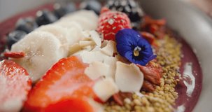 Close-up of beautiful healthy breakfast. Smoothies with blueberries, strawberries, banana and raspberries. 4k slow motion video