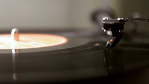 Vinyl lp record playing on a turntable isolated 