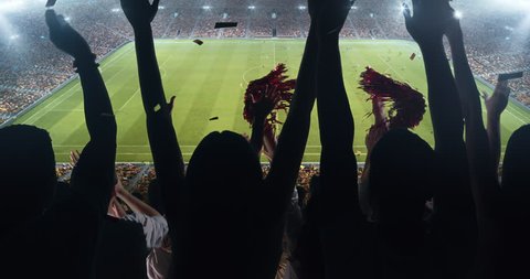 Fans clapping hands to cheer their favorite sports team on the stands of the professional stadium. Stadium is made in 3D and animated.