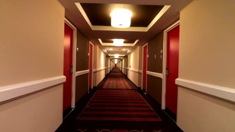 POV of walking in long corridor at a hotel
