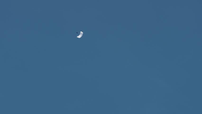 White parachute in blue sky