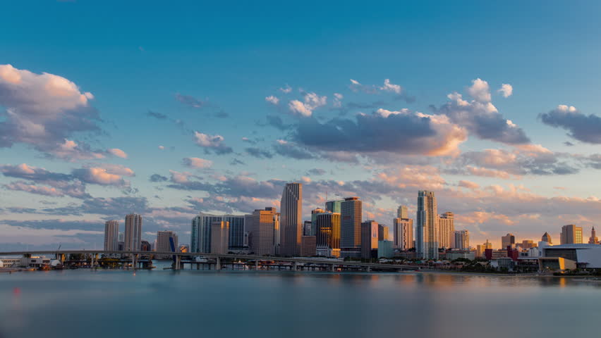 Day to night sunset timelapse hyperlaspe view of Miami downtown and Brickell skyline with I-95 Highway Bridge. Skyscrapers buildings in the back.